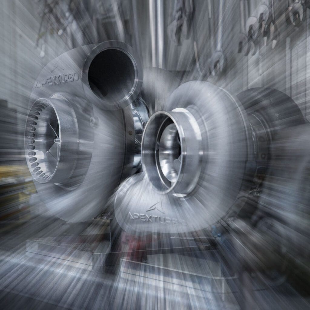 A blurry image of a turbocharger in a factory.